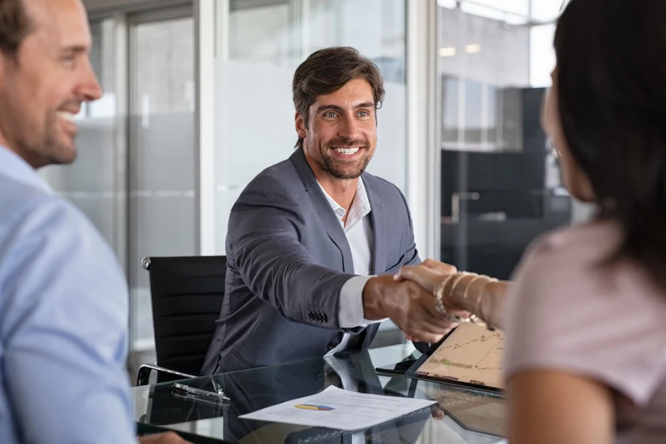 Banking professional welcoming customers to a consultation.