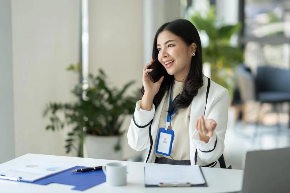 Sales professional speaking with a client by phone.