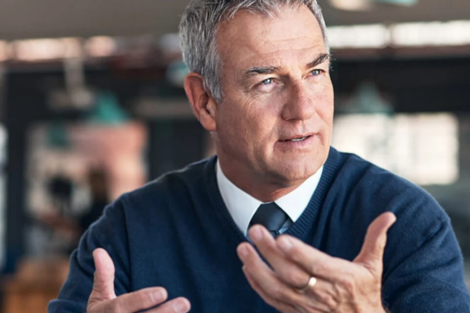 Senior banking professional discussing a finance decision.