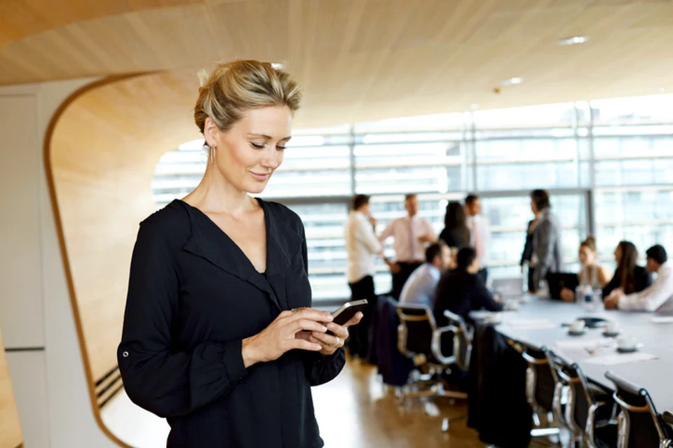 Banking professional coordinating work from a mobile device.