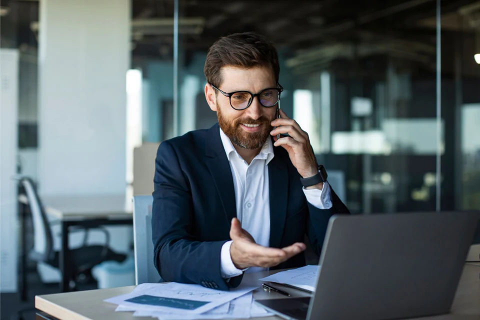 Broker speaking with a prospective customer by phone.
