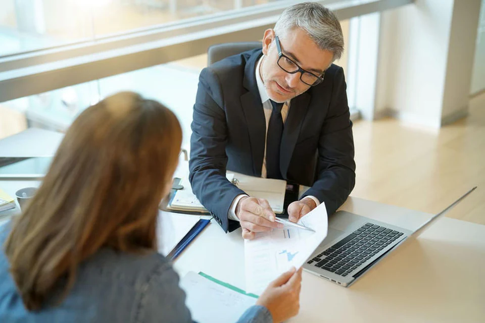 Finance adviser reviewing documents with a customer.